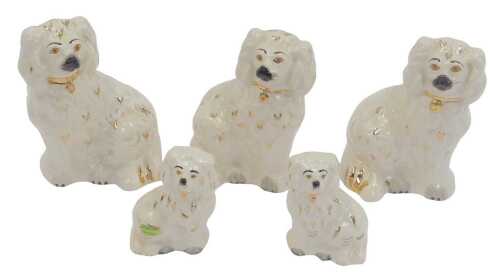 A group of Beswick Staffordshire style pottery spaniels, comprising three 15cm high, and two 9cm...