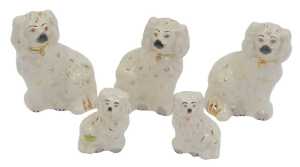 A group of Beswick Staffordshire style pottery spaniels, comprising three 15cm high, and two 9cm...