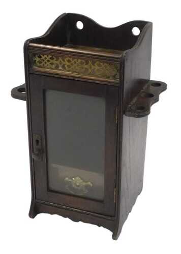 An Edwardian oak smoker's cabinet, the raised top with a pierced brass panel to the front, above...
