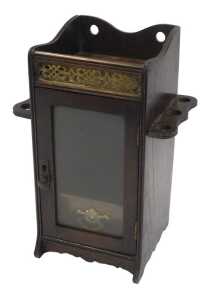 An Edwardian oak smoker's cabinet, the raised top with a pierced brass panel to the front, above...