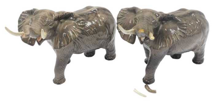Two Beswick pottery elephants, each modelled with trunk raised, 25cm high. (AF)