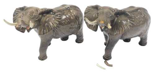 Two Beswick pottery elephants, each modelled with trunk raised, 25cm high. (AF)
