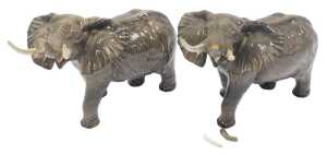 Two Beswick pottery elephants, each modelled with trunk raised, 25cm high. (AF)