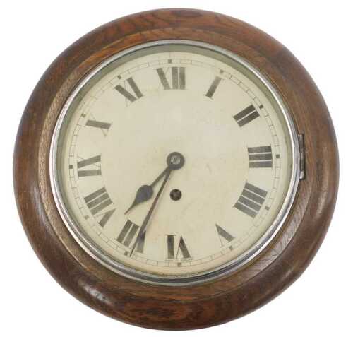 An early 20thC oak cased wall clock, the circular dial bearing Roman numerals, with a thirty...