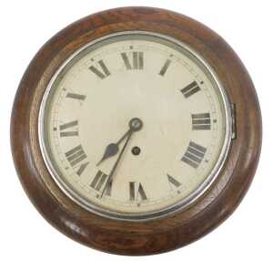 An early 20thC oak cased wall clock, the circular dial bearing Roman numerals, with a thirty...