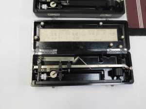 Two Allbrit planimeters, each in a black Bakelite case, 24.5cm wide, together with two... - 3