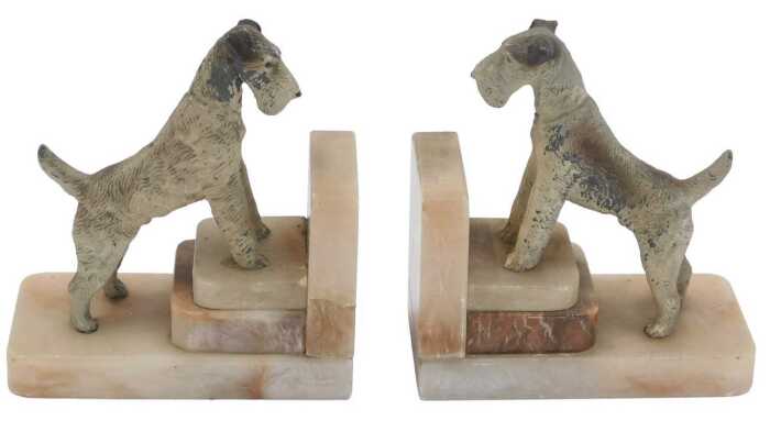 A pair of Art Deco marble bookends, each of L shaped stepped design, surmounted by a painted...