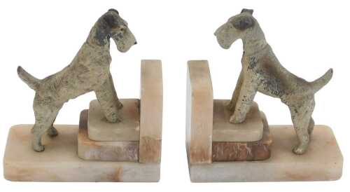 A pair of Art Deco marble bookends, each of L shaped stepped design, surmounted by a painted...