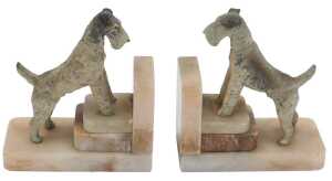 A pair of Art Deco marble bookends, each of L shaped stepped design, surmounted by a painted...
