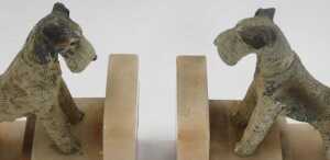 A pair of Art Deco marble bookends, each of L shaped stepped design, surmounted by a painted... - 2