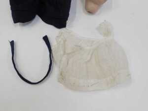A mid 20thC composition doll, wearing a bonnet and blue dress with a pinny, 22cm high, together... - 2