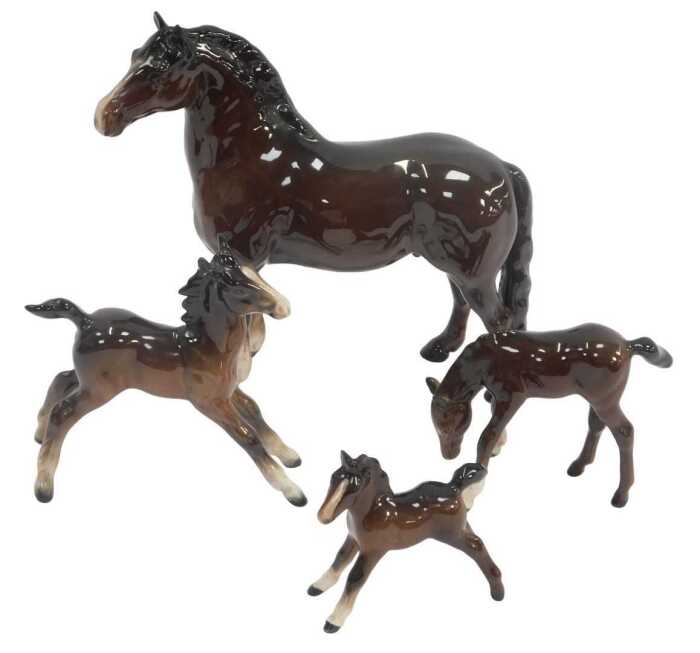 A Beswick brown bay pottery horse, 19cm high, together with three foals. (4, AF)