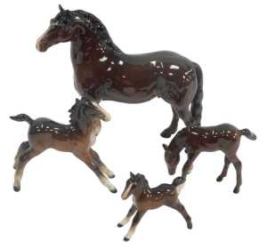 A Beswick brown bay pottery horse, 19cm high, together with three foals. (4, AF)
