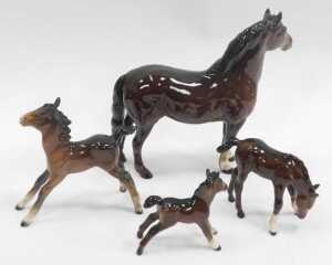A Beswick brown bay pottery horse, 19cm high, together with three foals. (4, AF) - 2