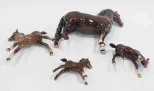 A Beswick brown bay pottery horse, 19cm high, together with three foals. (4, AF) - 3