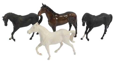 A Beswick pottery horse modelled as The Winner 2421, 24cm high, together with two matte...