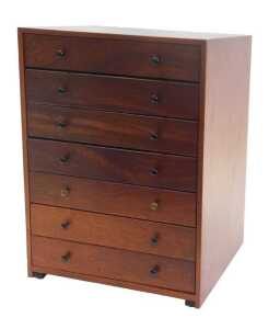 A 1970s teak tabletop chest, with a sloping top above five drawers, with a further faux drawer...