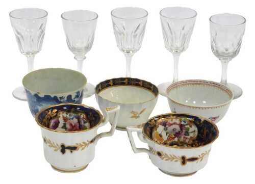 An 18thC Chinese blue and white tea bowl, together with a Chinese export famille rose tea bowl,...