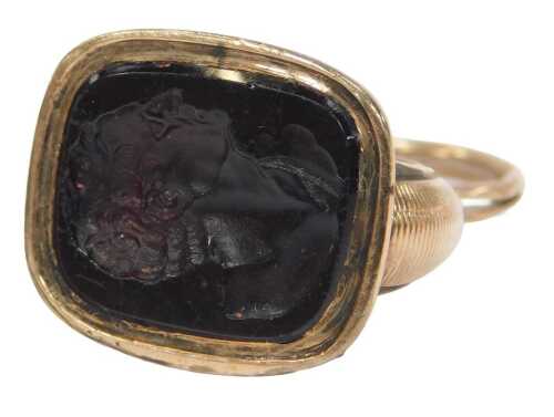An intaglio fob seal, the black onyx intaglio decorated with the head and shoulders portrait of...