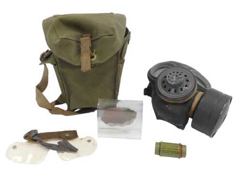 An Air Ministry World War II gas mask, contained in a green canvas case, together with an outfit...