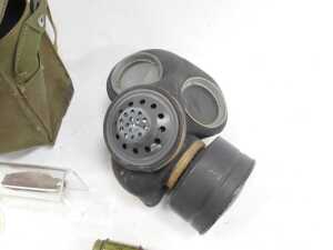 An Air Ministry World War II gas mask, contained in a green canvas case, together with an outfit... - 2