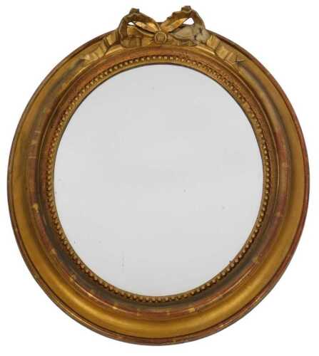 A 19thC giltwood mirror, of oval form, with an inner beaded border, the base decorated with a...