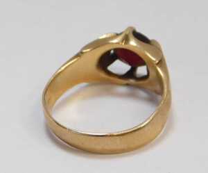 A 9ct gold and garnet single-stone ring, the oval garnet in a four-claw setting, size Q&frac12;, 5.3g... - 2