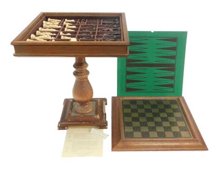 A Studio Anne Carlton Battle of Hastings resin chess set, contained in an oak chess table, 62cm...