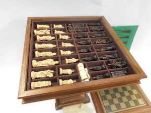 A Studio Anne Carlton Battle of Hastings resin chess set, contained in an oak chess table, 62cm... - 2