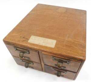 An early 20thC oak four-drawer tabletop filing cabinet, with metal lobed handles and integrated... - 2
