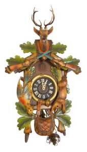 A West German Black Forest style part painted cuckoo clock, decorated with carved animals,...