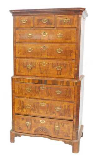 A George II walnut chest on chest, the upper section with canted moulded cornice above fluted...