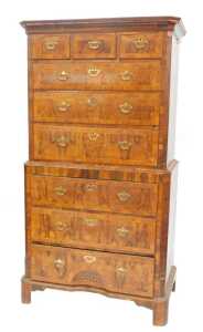 A George II walnut chest on chest, the upper section with canted moulded cornice above fluted...