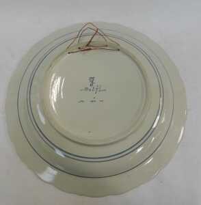 A 20thC Delft pottery charger, decorated centrally with a windmill before a river, within a... - 3