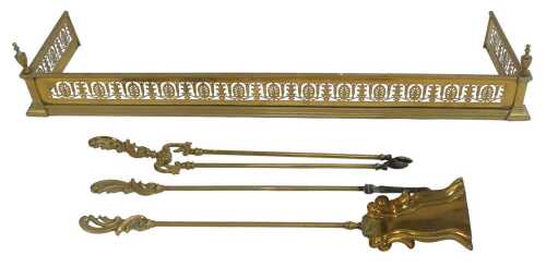 A group of Victorian brass fireside items, comprising a fender, with pierced border and urn...