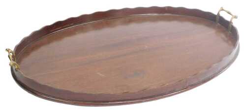 A 19thC mahogany galleried oval tray, with a wave border and brass handles, 70cm wide.