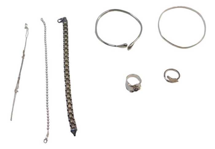 A group of silver and other costume jewellery, comprising two splayed twist bangles, a bead link...