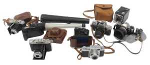 A group of cameras, to include Canon EOS 650 SLR camera, and Olympus OM10, Ricoh TLS 401, etc....
