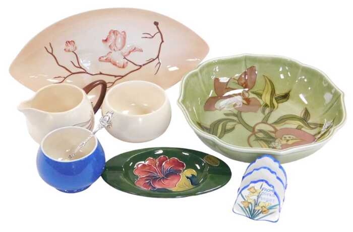 A group of Carltonware and Moorcroft pottery, including a Moorcroft Hibiscus pattern ashtray, a...