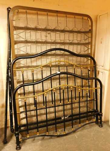 A black painted cast metal and brass Victorian style double bed frame, comprising headboard,...