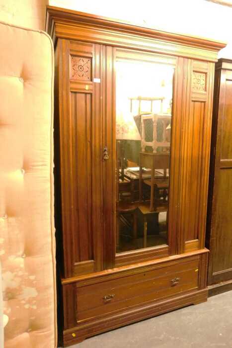 A Victorian mahogany wardrobe, the top with a moulded pediment above a single drawer glazed door,...