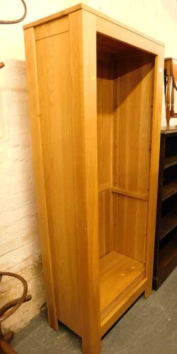 A contemporary oak bookcase, with five shelves, raised on stiles, 175cm high, 71cm wide, 40cm deep.