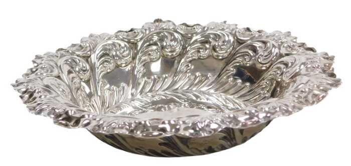 A Victorian silver sweetmeat dish, with a crimped rim, embossed with foliate and C scrolls,...