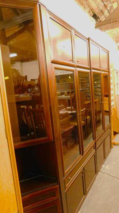 A 20thC room unit, in four parts, comprising two sections each with two cupboard doors, two...