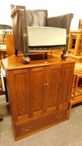 An oak television cabinet, with folding panelled doors and a door to the base, together with a...