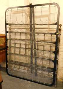 A Victorian style cast metal and brass double bed, comprising headboard, footboard, sprung base...