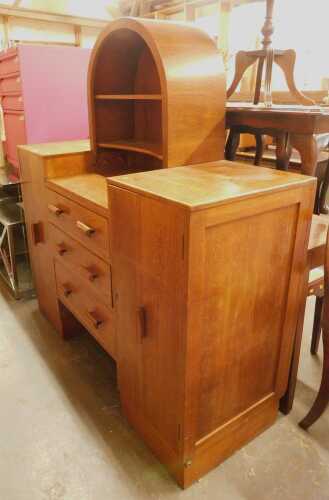 An early 20thC oak sideboard, the inverted top with a shelved section above three drawers...