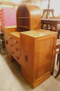 An early 20thC oak sideboard, the inverted top with a shelved section above three drawers...