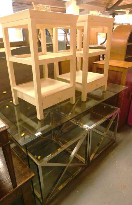 A glass topped desk, on glass end supports, 76cm high, the top 138cm x 70cm, together with two...
