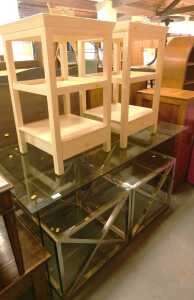 A glass topped desk, on glass end supports, 76cm high, the top 138cm x 70cm, together with two...